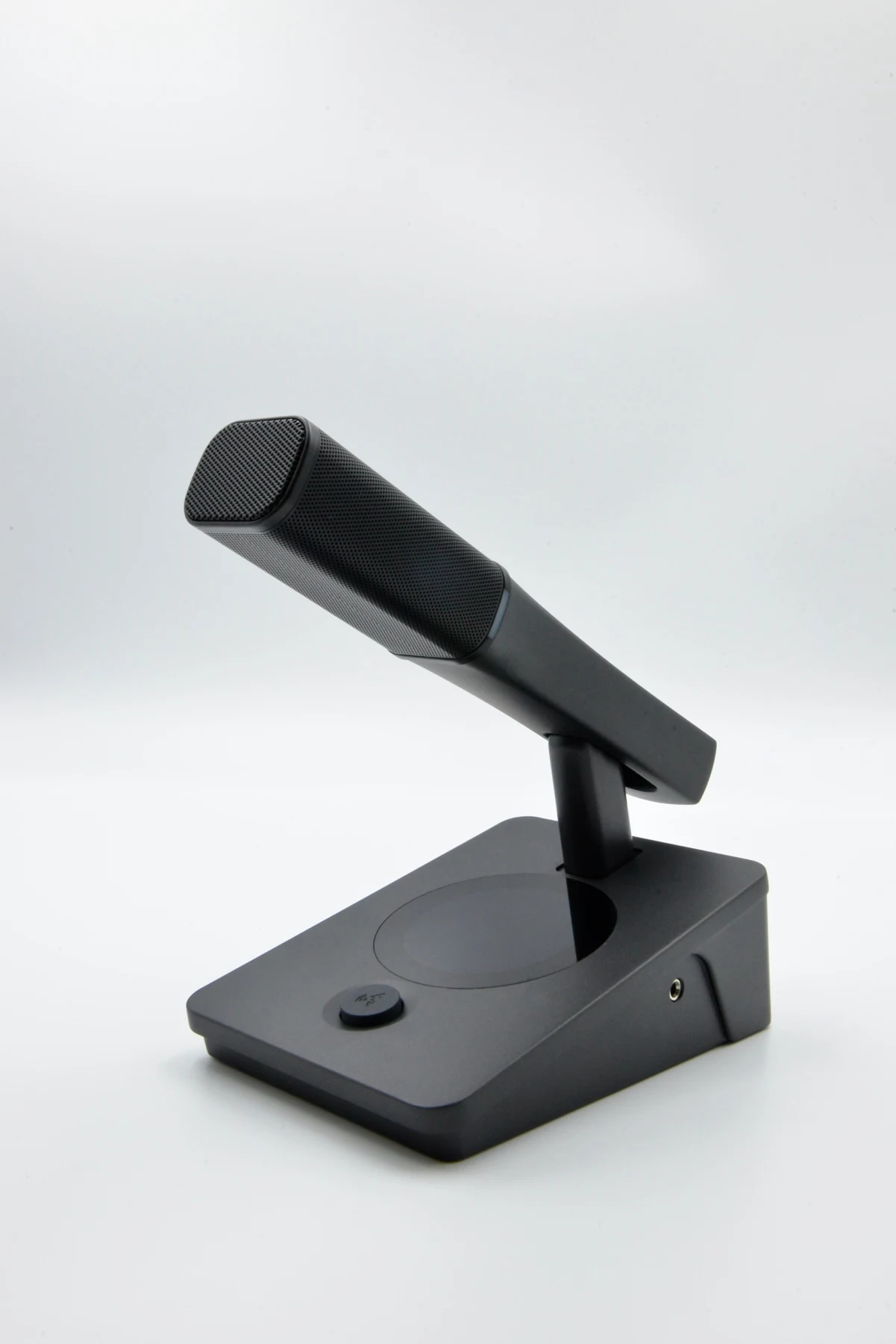 Original photograph of a desktop discussion unit with short metal microphone and headphone socket